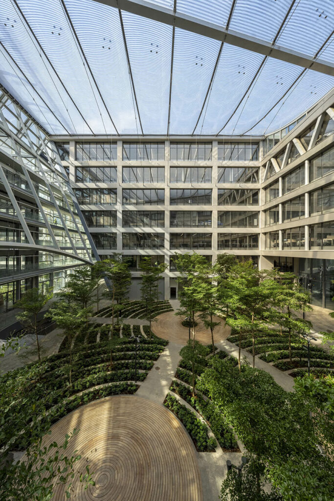 ETFE Singapore: Surbana Jurong Campus features cable-supported ETFE atrium roofs that deliver daylight, comfort, and energy efficiency in two indoor garden courtyards.
