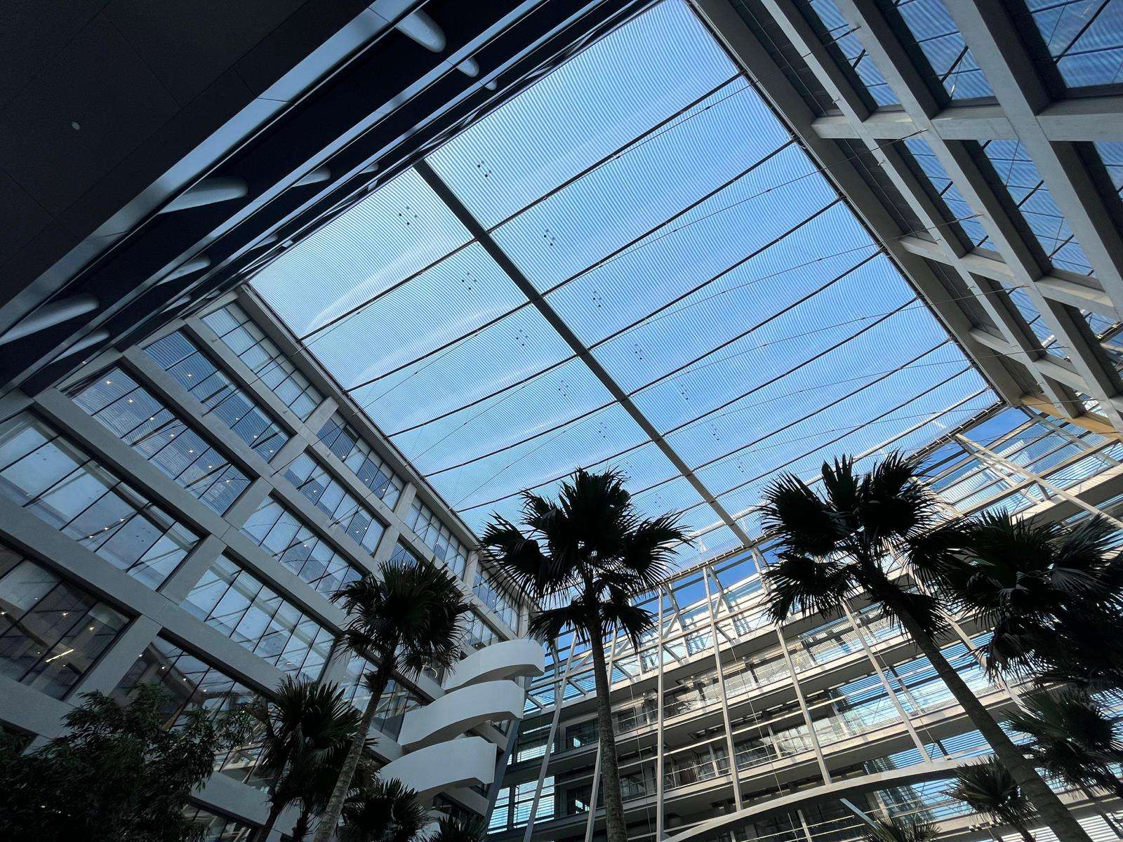 ETFE Singapore: Surbana Jurong Campus features cable-supported ETFE atrium roofs that deliver daylight, comfort, and energy efficiency in two indoor garden courtyards.