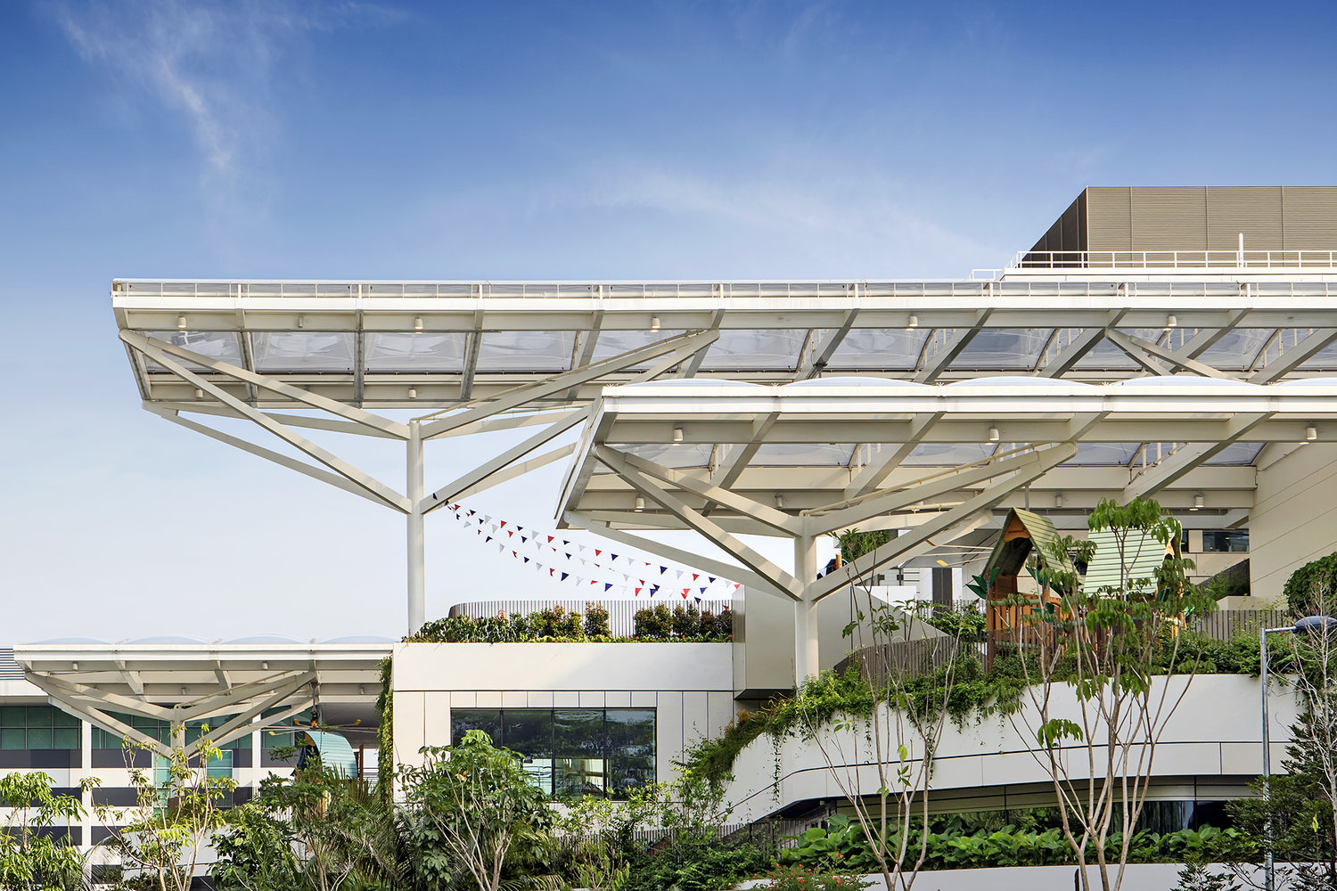 ETFE Singapore: Early Learning Village in Singapore uses 3,000 m² of ETFE canopies to shelter outdoor play, learning and pool spaces with UV protection and daylight control.
