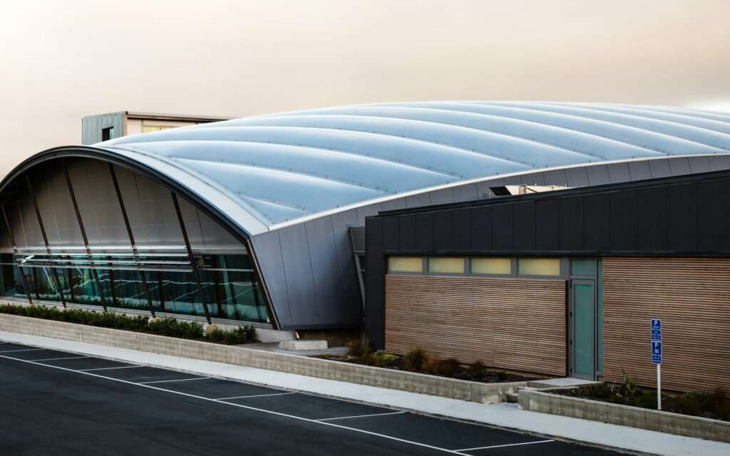 ETFE New Zealand: Coastlands Aquatic Centre features a double-curved ETFE roof over a timber structure, delivering daylight, efficiency and award-winning sustainable performance.