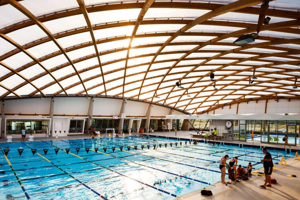 ETFE New Zealand: Coastlands Aquatic Centre features a double-curved ETFE roof over a timber structure, delivering daylight, efficiency and award-winning sustainable performance.