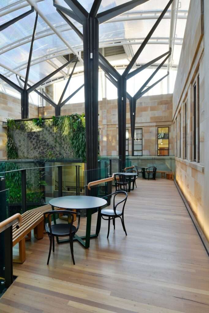 ETFE Australia: Global Change Institute in Brisbane features a 497 m² ETFE atrium roof with three-layer cushions and printed grid foils, combining natural light and heat control for a zero-energy, zero-carbon educational facility.