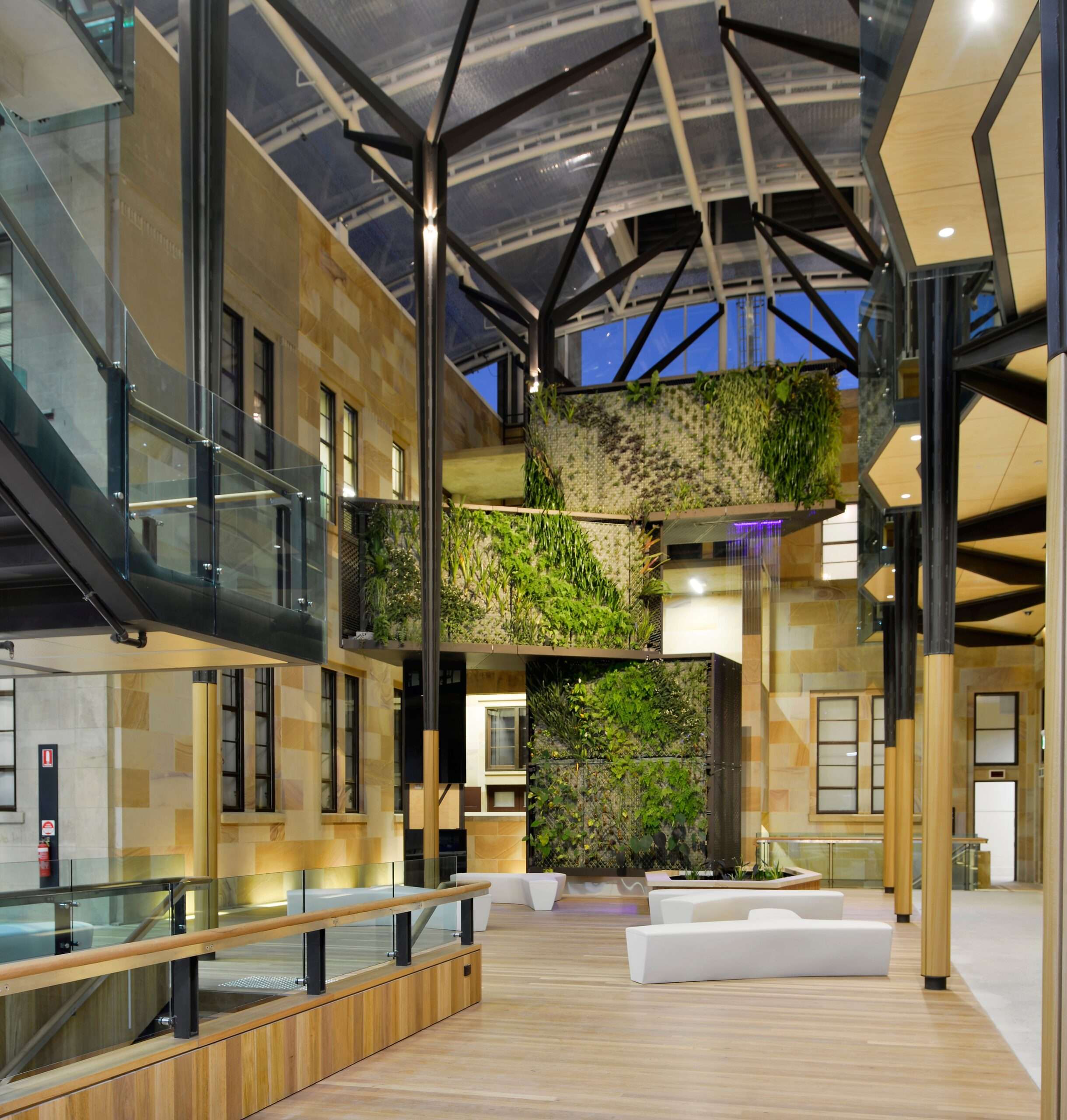 ETFE Australia: Global Change Institute in Brisbane features a 497 m² ETFE atrium roof with three-layer cushions and printed grid foils, combining natural light and heat control for a zero-energy, zero-carbon educational facility.