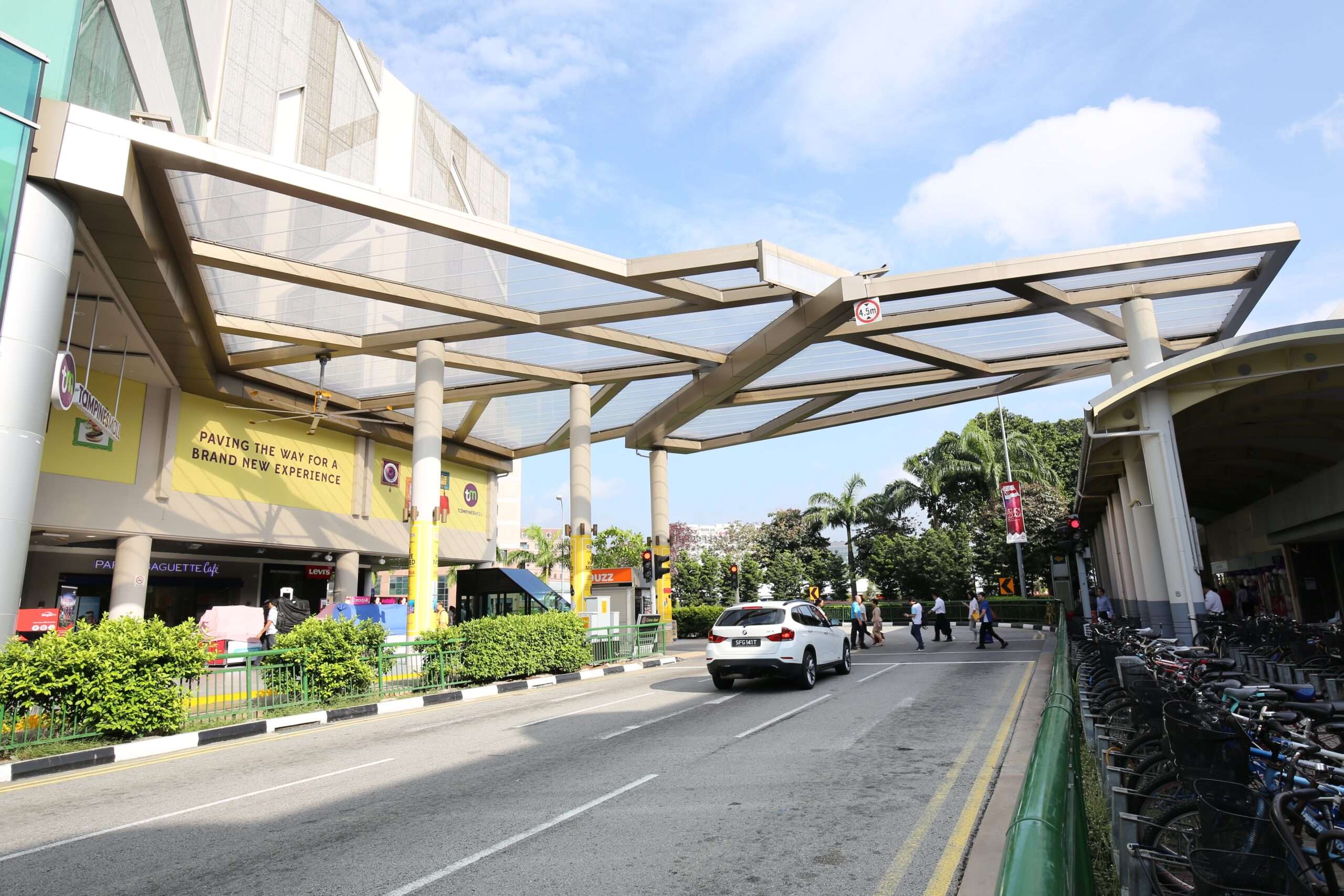 Tampines Mall features a 440 m² single-layer ETFE canopy linking the mall to the MRT station, providing pedestrians shade and rain protection.