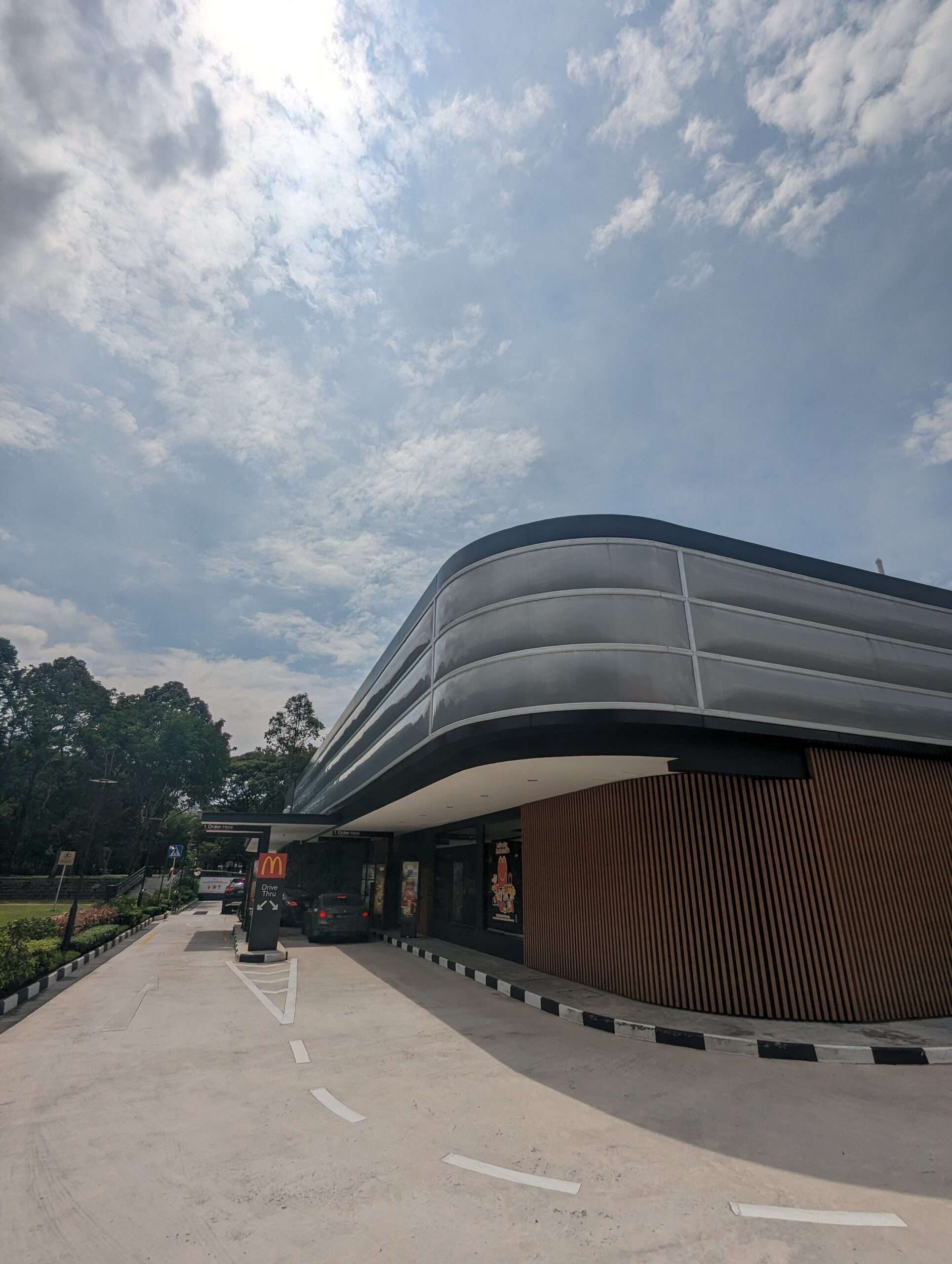 ETFE Singapore: McDonald’s at Choa Chu Kang Park features a lightweight ETFE facade providing shade and rain protection for an open park pavilion.
